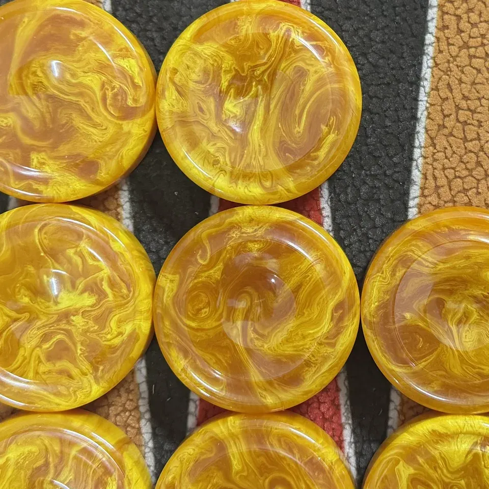 Marbled yellow Catalin checkers on the points of a board
